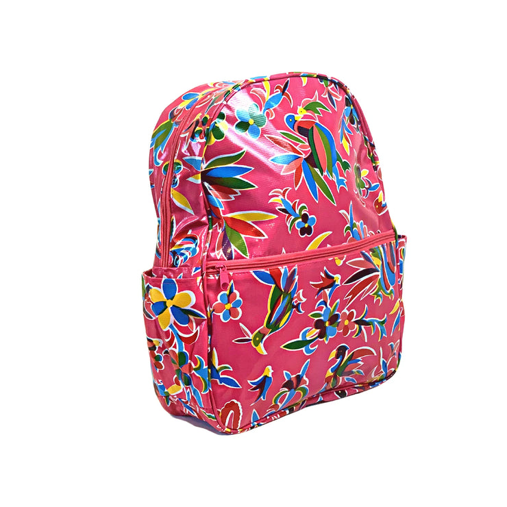 Side view: Otomi Backpack with multi-colored flower/animal print on pink background.