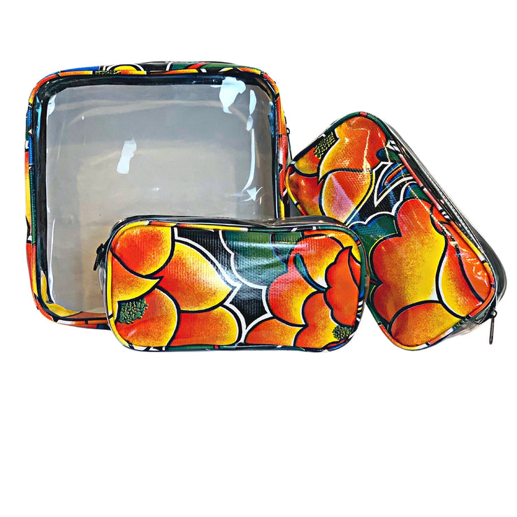 Front view: One large and two small travel cases, multi-colored floral print on black background.