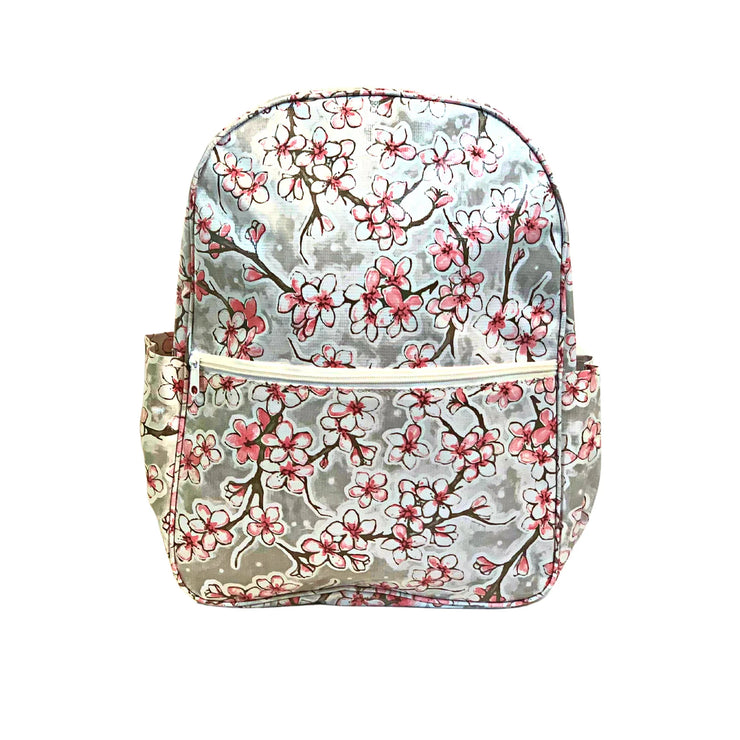 Front view: Sakura Backpack, cherry blossom print on gray background.