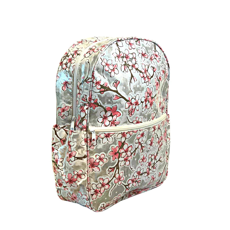 Side view: Sakura Backpack, cherry blossom print on gray background.