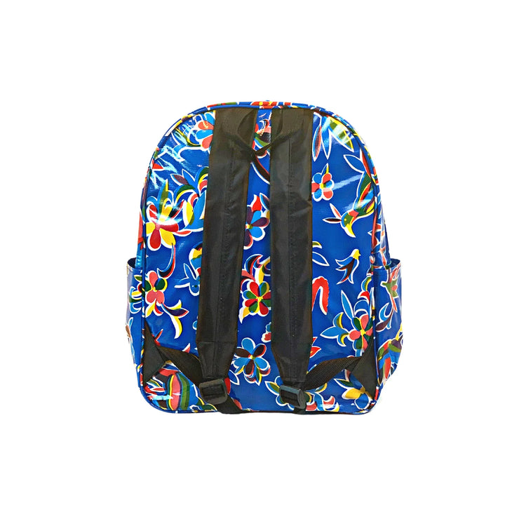 Back view: Otomi backpack with multi-colored flower/animal print on blue background, black shoulder straps and black grab handle.