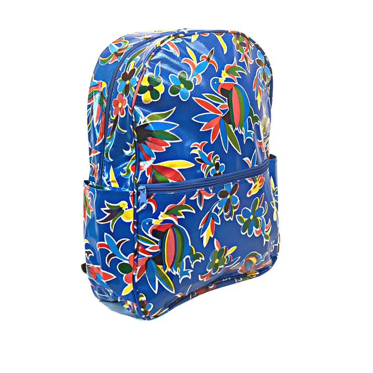 Side view: Otomi backpack with multi-colored flower/animal print on blue background.