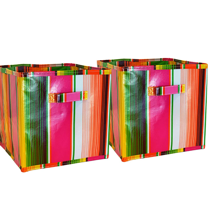 Front view: Two collapsable storage bins, multi-colored vertical striped pattern.