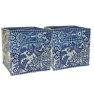 Front view: Two collapsable storage bins, navy and blue floral/leaf pattern, on light blue background.