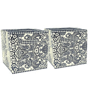 Front view: Two collapsable storage bins, black floral/leaf pattern, on white background.