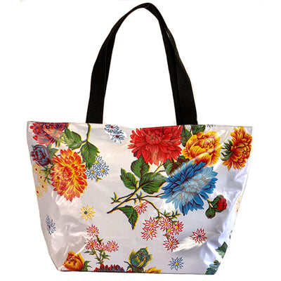 Front: Multi-color floral print on white background tote with black grab handles.